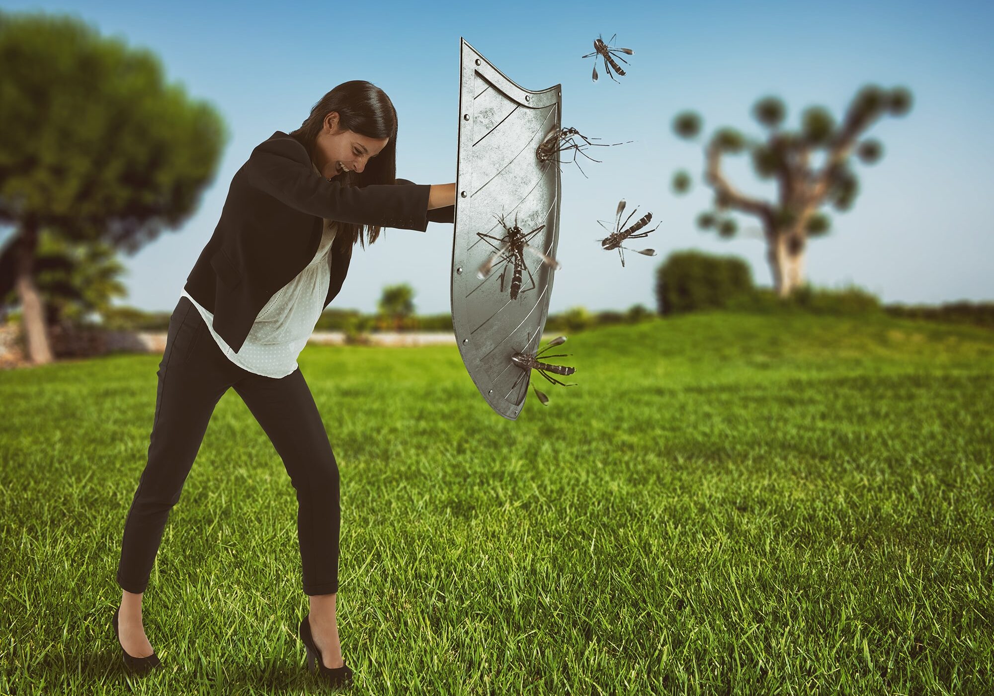 Woman defends herself from the attack of mosquitoes with a shield