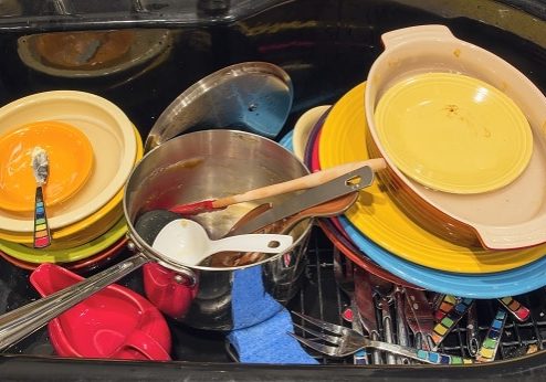 Kitchen Sink with Dirty Dishes Utensils and Pot