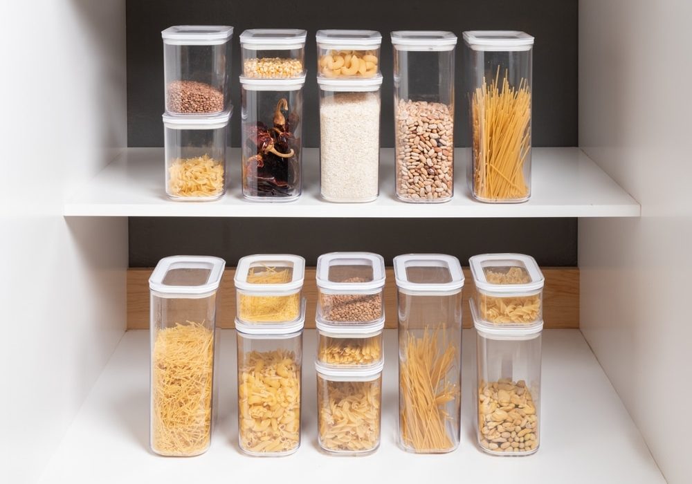 Organized,Kitchen,Cabinet,With,Multiple,Stackable,Clear,Containers,Displaying,A Organized Kitchen Cabinet with Multiple Stackable Clear Containers