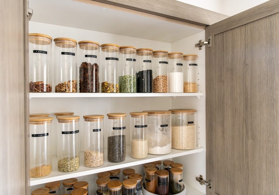 Neatly organized labeled food pantry in a home kitchen