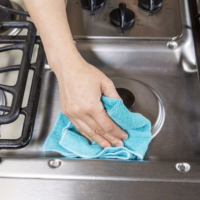 Wiping down stainless steel stove top range